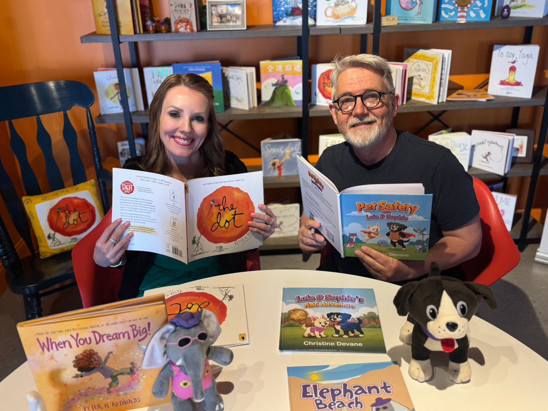 Christine Devane and Peter Reynolds at The Reynolds Learning Center holding children's books