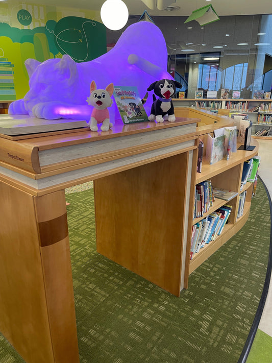 Christine Devane's books and character plush toys displayed at the Boston Public Library