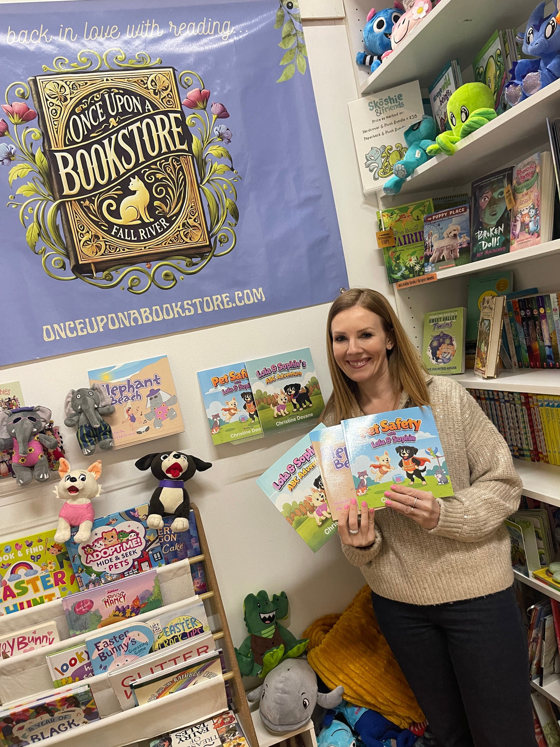 Christine Devane with her books and stuffed animals at Once Upon a Bookstore in Fall River