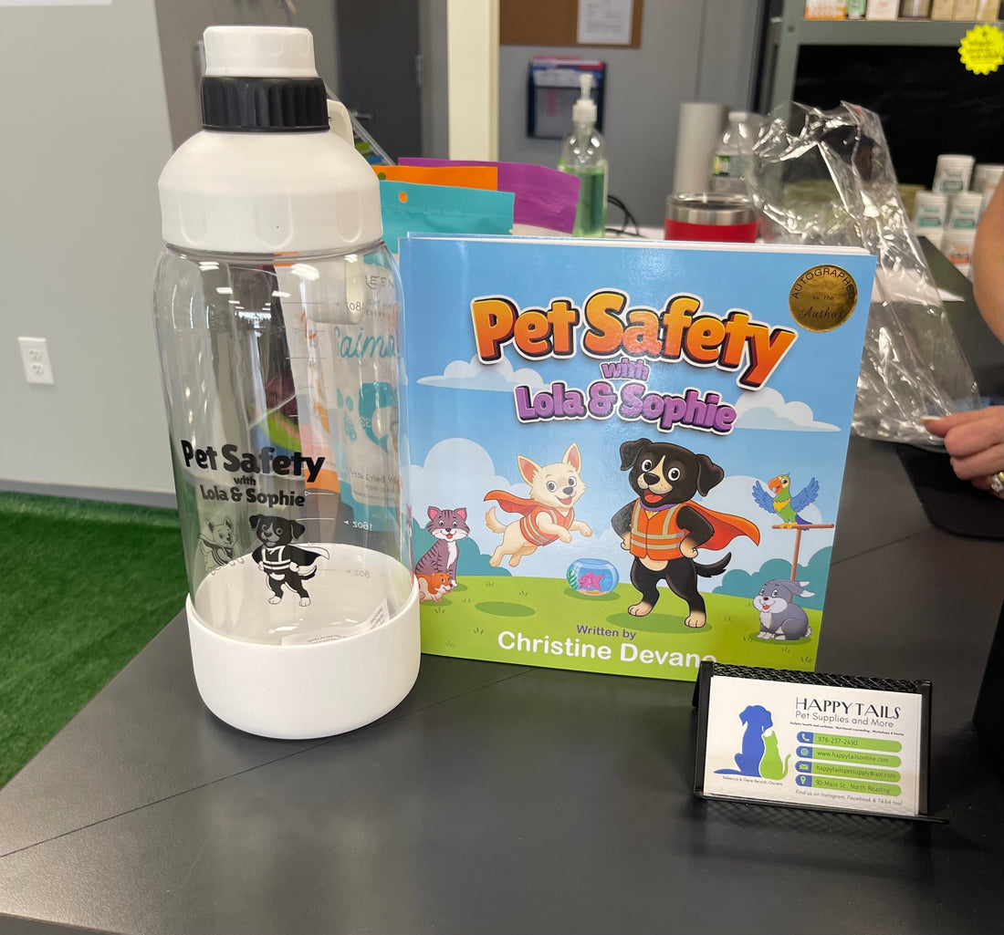 Pet Safety with Lola & Sophie book and branded water bottle displayed at Happy Tails Pet Supplies in North Reading
