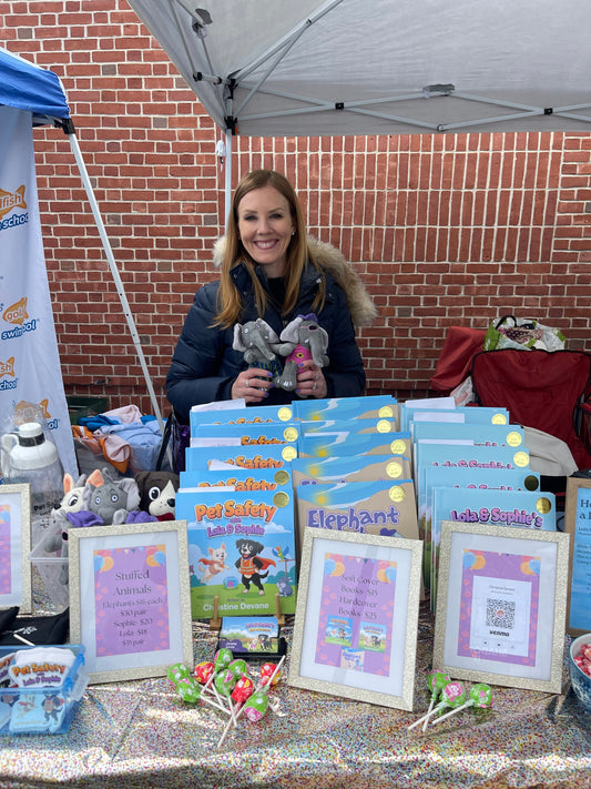 Christine Devane at her Walpole Day booth with Pet Safety books and stuffed animals