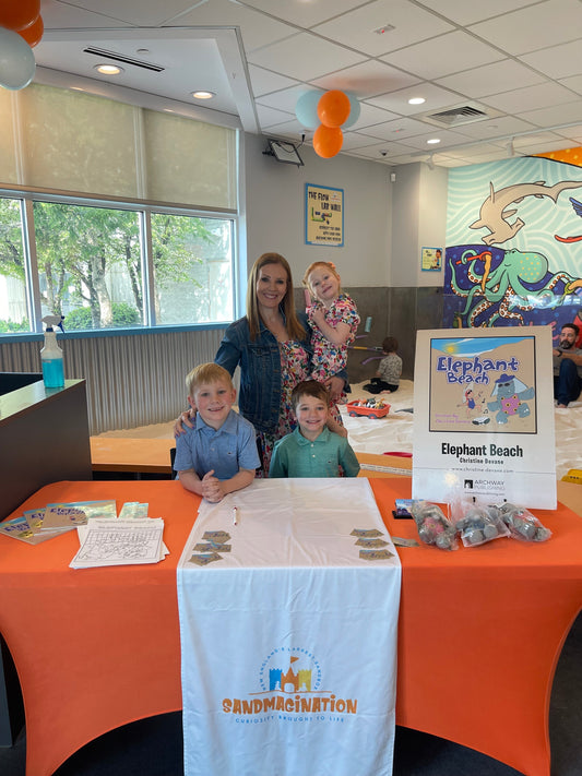 Christine Devane at the Sandmagination anniversary event on Mother's Day with children at the Elephant Beach book signing table