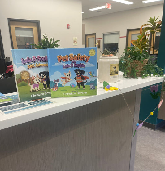 Lola & Sophie books displayed in the waiting room at Massachusetts Referral Vet in Woburn, MA